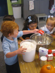 Preschoolers learning to bake together