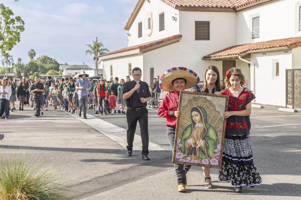 Students march in a procession for Hispanic Heritage Month